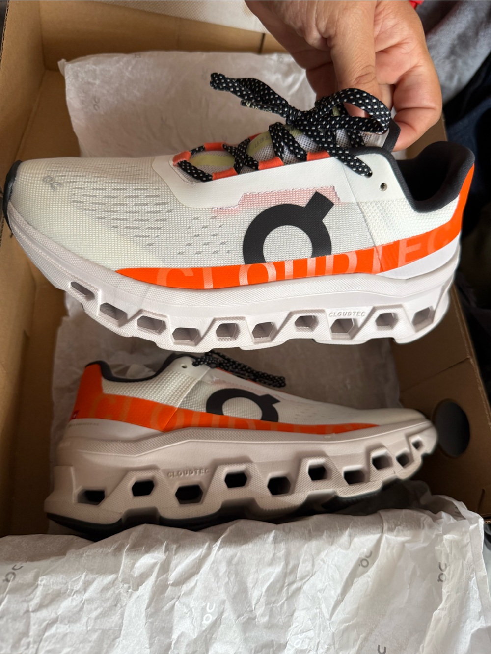 On Running Cloud-like Sneakers in White and Orange with Black Accents
